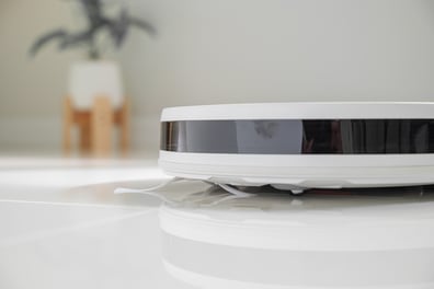close-up-of-a-white-robot-vacuum-web