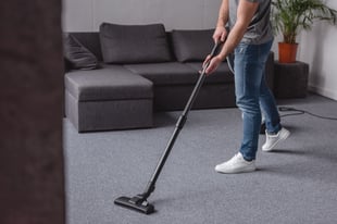 cropped-image-of-man-cleaning-carpet-with-vacuum-c-2022-12-16-16-33-33-utc