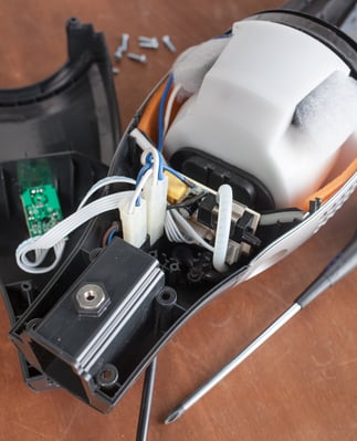 disassembled-vacuum-cleaner-on-a-wooden-surface-web