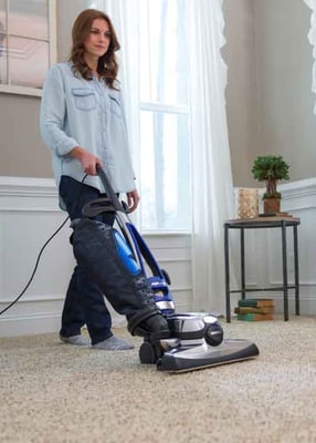 Woman vacuuming carpet with Kirby Avalir 2.