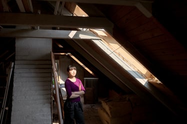 woman-in-old-attic-looking-at-sunlight-2021-08-28-23-57-01-utc