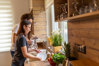 woman-washing-the-dishes-while-man-is-drying-them-2023-12-19-17-08-35-utc